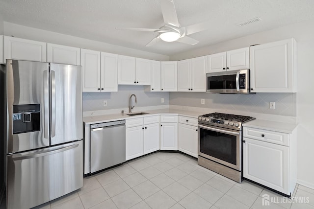 116 Prestwick Way, Edison, NJ 08820 - kitchen with stainless steel appliances, light countertops, white cabinets, ceiling fan, and a textured ceiling