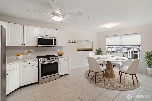 116 Prestwick Way, Edison, NJ 08820 - kitchen featuring gas stove, light countertops, decorative backsplash, and white cabinetry