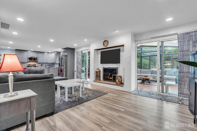 19 Ellen Cir, Old Bridge, NJ 08857 - living area featuring light wood-type flooring, a fireplace, and recessed lighting