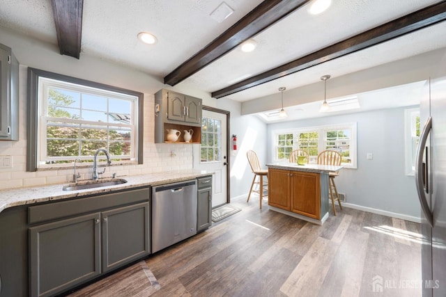 201 Summit Ave, Fords, NJ 08863 - kitchen featuring appliances with stainless steel finishes, gray cabinetry, beam ceiling, wood finished floors, and tasteful backsplash