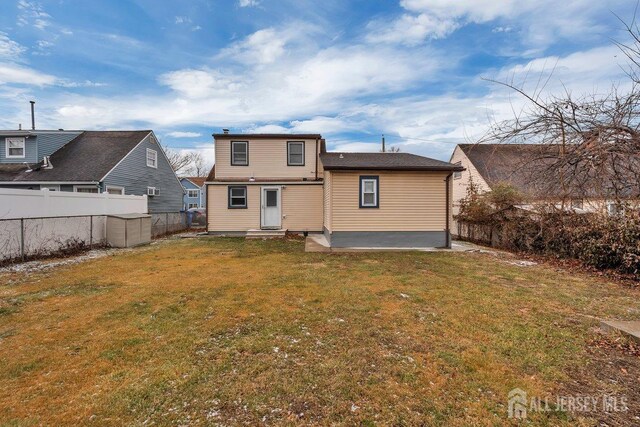 back of property featuring a patio and a lawn