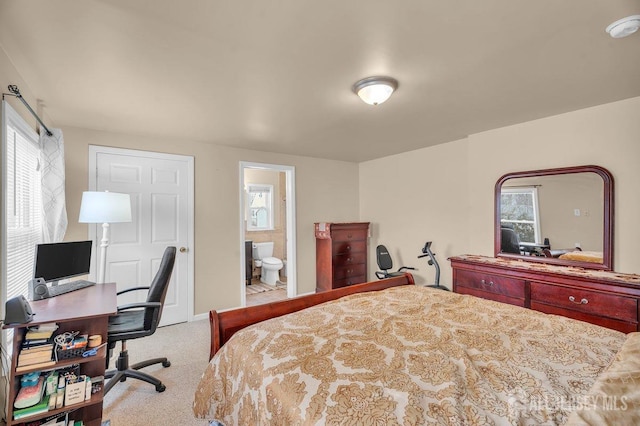 bedroom featuring multiple windows, connected bathroom, and carpet flooring