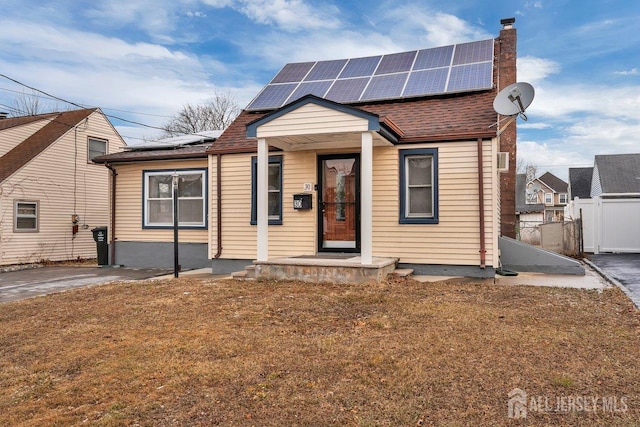 bungalow-style house with solar panels