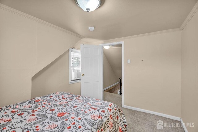 bedroom with ornamental molding and light carpet