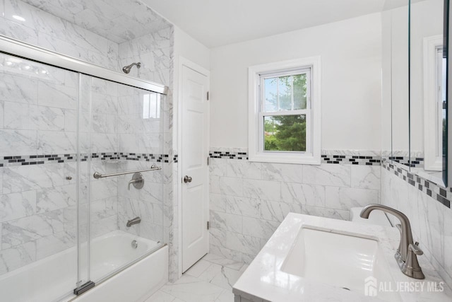 118 Hillside Ave, Woodbridge Proper, NJ 07095 - full bathroom featuring tile walls, bath / shower combo with glass door, vanity, marble finish floors, and a wainscoted wall
