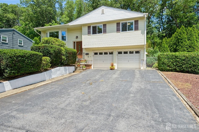 34 Bartman Rd, East Brunswick, NJ 08816 - bi-level home featuring asphalt driveway and a garage