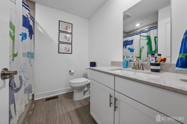 full bathroom with vanity, wood finished floors, visible vents, curtained shower, and toilet