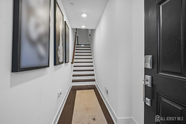 hall with stairway, baseboards, and dark wood-style flooring