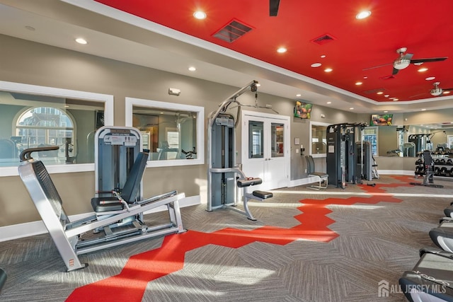 workout area featuring visible vents, a tray ceiling, recessed lighting, carpet floors, and baseboards