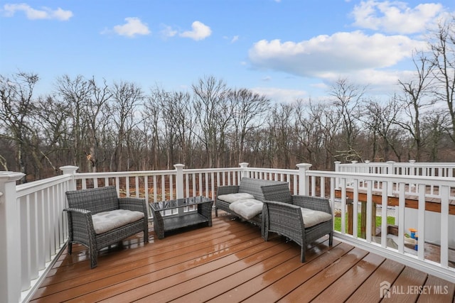 wooden terrace featuring outdoor lounge area