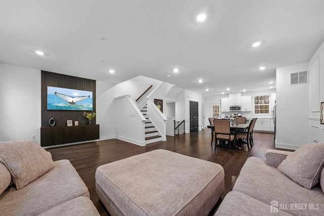 living area featuring visible vents, recessed lighting, stairs, and dark wood-style flooring