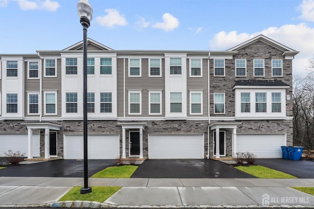 view of property with an attached garage and driveway