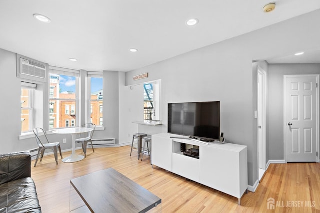 living room featuring light wood-style floors, recessed lighting, and baseboards