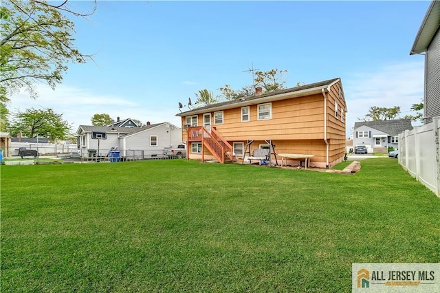 20 Kennedy St, Iselin, NJ 08830 - back of property with stairway, a fenced backyard, and a chimney