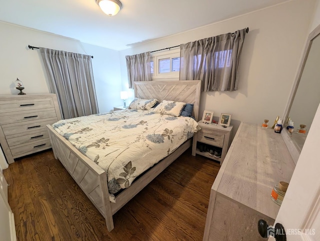 bedroom with dark wood finished floors