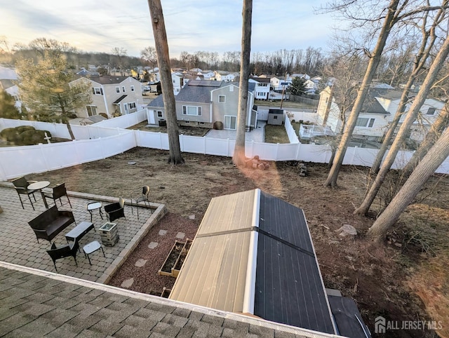 exterior space with a patio, a fenced backyard, and a residential view