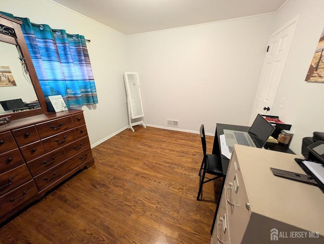 office area featuring baseboards, visible vents, and wood finished floors