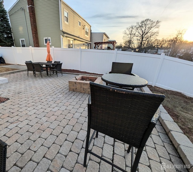 view of patio / terrace featuring a fenced backyard, a fire pit, and outdoor dining area