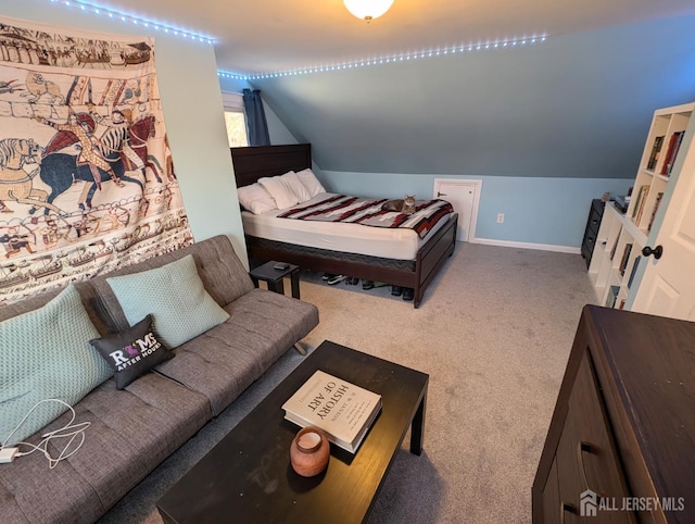 carpeted bedroom with lofted ceiling and baseboards