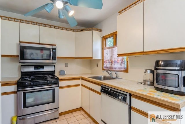 5 Berkley Blvd, Iselin, NJ 08830 - kitchen with stainless steel appliances, a sink, light countertops, ceiling fan, and light tile patterned floors