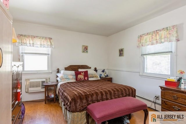5 Berkley Blvd, Iselin, NJ 08830 - bedroom featuring a baseboard heating unit, multiple windows, light wood-style flooring, and a wall unit AC