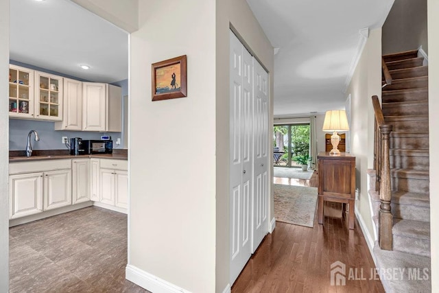 223 Perth Hill Ct, Matawan, NJ 07747 - kitchen with a sink, dark countertops, glass insert cabinets, and baseboards