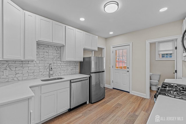 307 Wayne St, Highland Park, NJ 08904 - kitchen featuring appliances with stainless steel finishes, tasteful backsplash, light wood-style flooring, light countertops, and recessed lighting