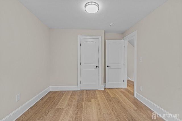 307 Wayne St, Highland Park, NJ 08904 - unfurnished bedroom with light wood-style flooring and baseboards