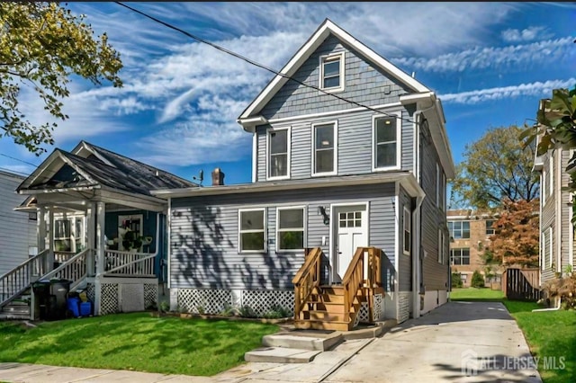 307 Wayne St, Highland Park, NJ 08904 - view of front of house featuring a front lawn and a porch