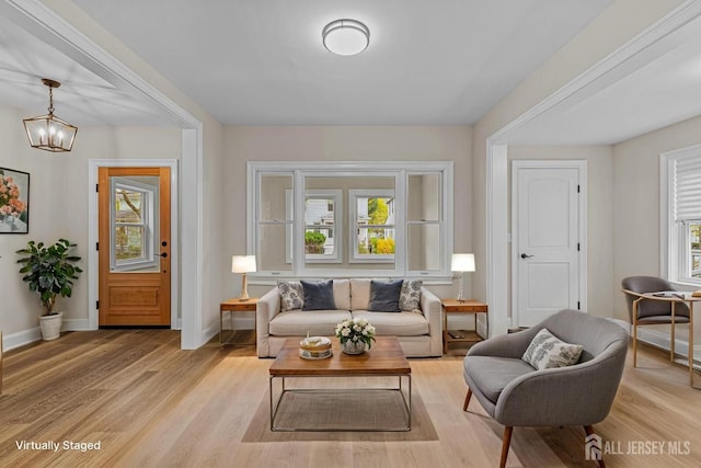 307 Wayne St, Highland Park, NJ 08904 - living room with healthy amount of natural light, light wood-style floors, and a chandelier