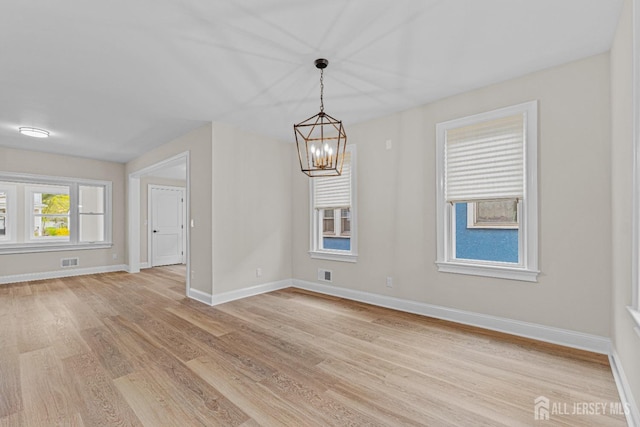 307 Wayne St, Highland Park, NJ 08904 - empty room with light wood-style floors and a chandelier