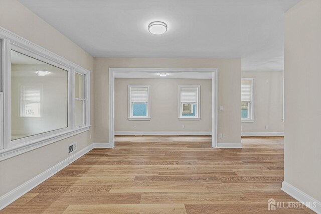 307 Wayne St, Highland Park, NJ 08904 - empty room with light wood-type flooring and healthy amount of natural light