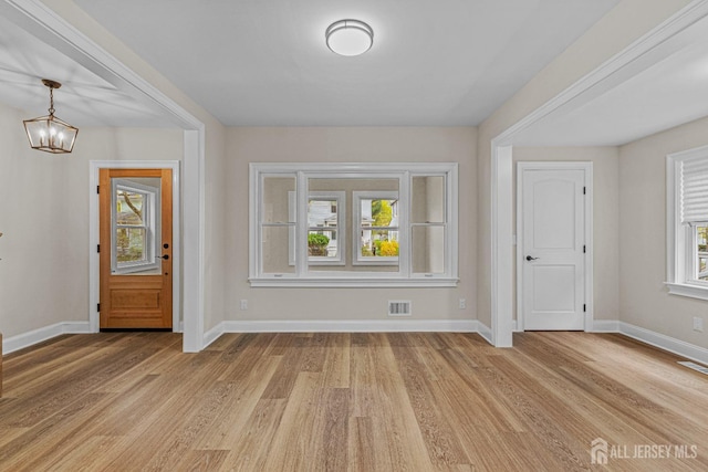 307 Wayne St, Highland Park, NJ 08904 - entrance foyer featuring healthy amount of natural light, light wood finished floors, and a chandelier