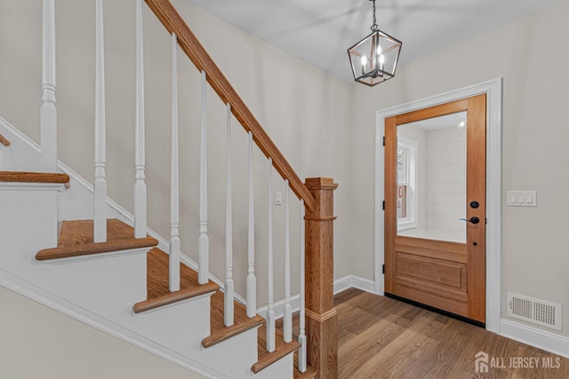 307 Wayne St, Highland Park, NJ 08904 - entrance foyer featuring stairway, wood finished floors, and a chandelier