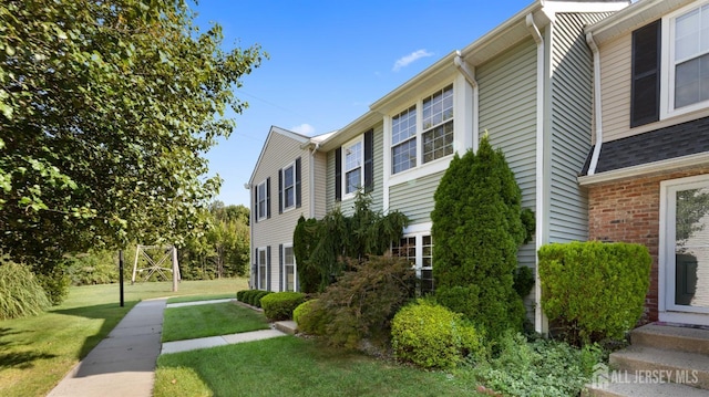 view of side of home with a lawn