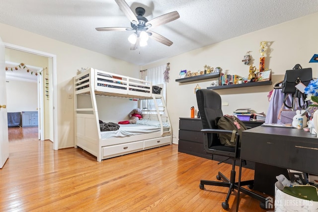 bedroom with wood-type flooring, a ceiling fan, and a textured ceiling