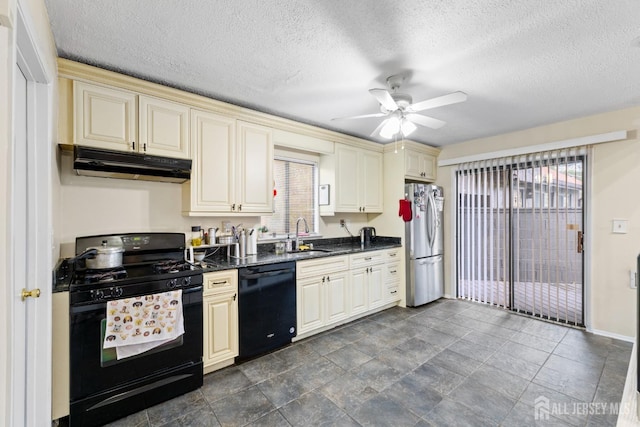 kitchen featuring a ceiling fan, black appliances, cream cabinetry, under cabinet range hood, and a sink