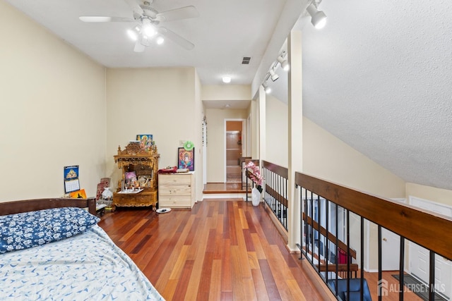 bedroom with visible vents, ceiling fan, and wood finished floors