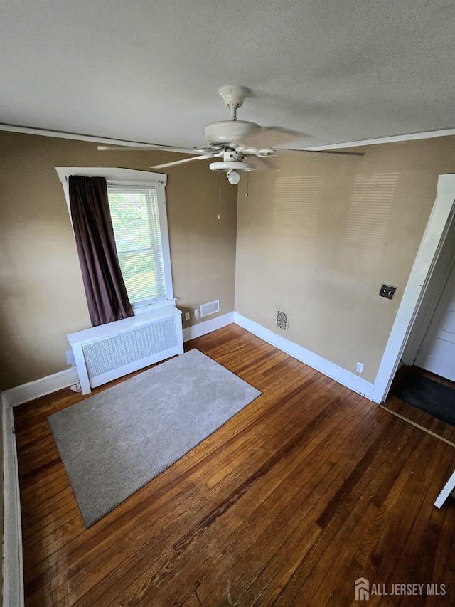237 Prospect Ave, Dunellen, NJ 08812 - spare room with radiator heating unit, a ceiling fan, wood finished floors, ornamental molding, and a textured ceiling