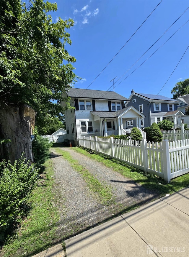 237 Prospect Ave, Dunellen, NJ 08812 - view of front of house featuring driveway and a fenced front yard