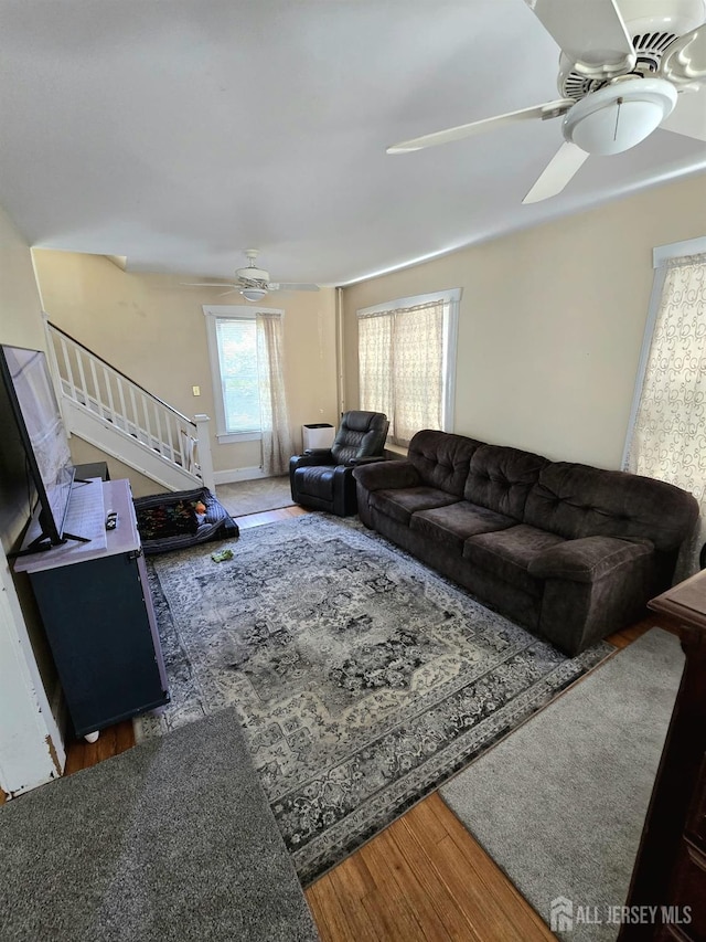 237 Prospect Ave, Dunellen, NJ 08812 - living area with ceiling fan, stairway, and wood finished floors