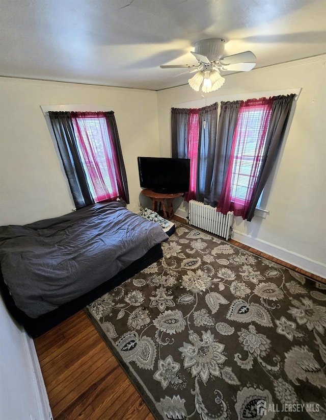 237 Prospect Ave, Dunellen, NJ 08812 - bedroom featuring radiator, wood finished floors, and a ceiling fan