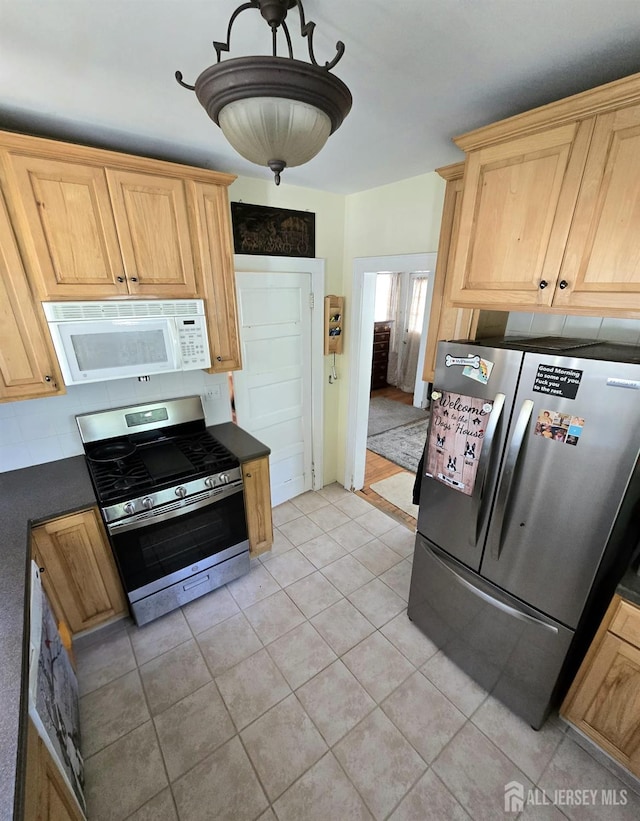 237 Prospect Ave, Dunellen, NJ 08812 - kitchen with stainless steel appliances, dark countertops, light tile patterned flooring, and light brown cabinetry