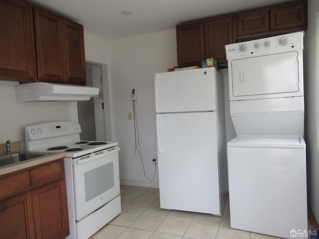 68 Macarthur Ave, Sayreville, NJ 08872 - kitchen featuring white appliances, under cabinet range hood, estacked washer and dryer, a sink, and light tile patterned flooring