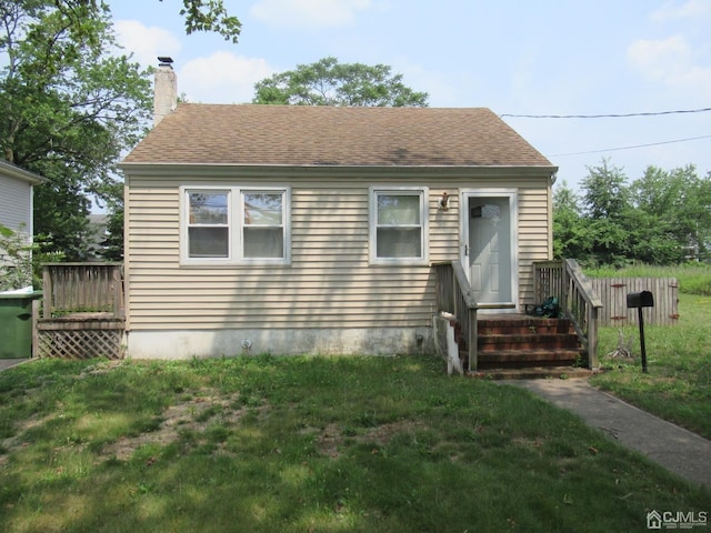 68 Macarthur Ave, Sayreville, NJ 08872 - view of front of home featuring a chimney, a front lawn, and roof with shingles