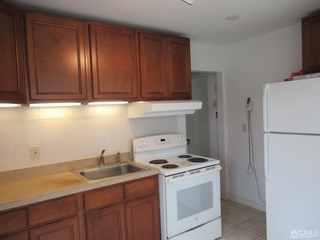 68 Macarthur Ave, Sayreville, NJ 08872 - kitchen with white appliances, a sink, under cabinet range hood, light tile patterned floors, and backsplash