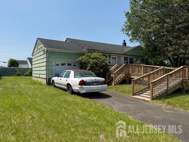 397 Lake Ave, Colonia, NJ 07067 - view of front of home featuring an attached garage, a front lawn, driveway, and stairs