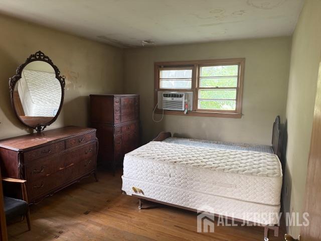 397 Lake Ave, Colonia, NJ 07067 - bedroom with wood finished floors and cooling unit