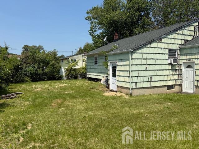 397 Lake Ave, Colonia, NJ 07067 - view of home's exterior with a lawn and a shingled roof