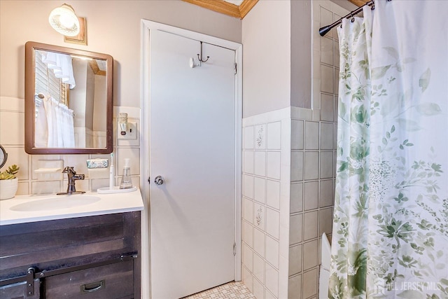 bathroom featuring curtained shower, tile walls, and vanity